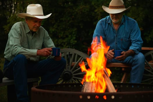Two men sitting by a fire