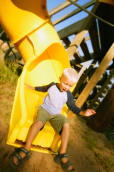 Boy goes down a slide