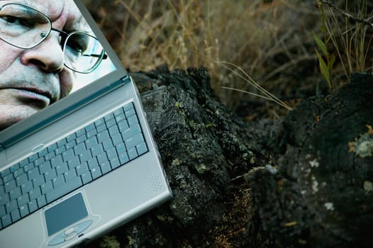 Man's face on laptop computer