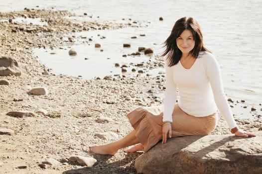 Woman sits on the beach