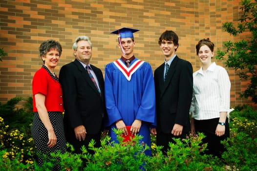 Graduate poses for family photo