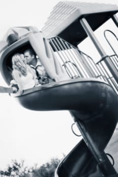 Couple kiss on a slide