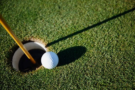 Golf ball close to pin