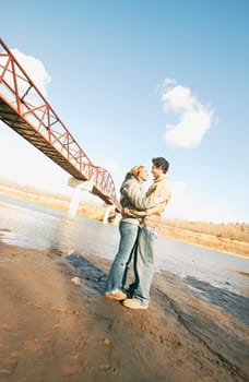 Couple embrace in river valley