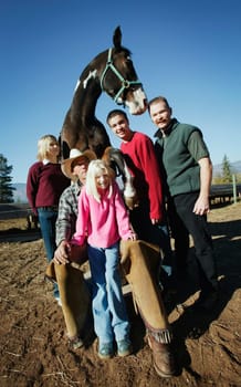 Family poses with a horse