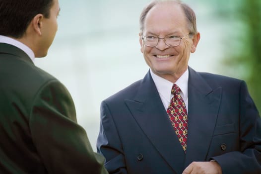 Two businessmen talk