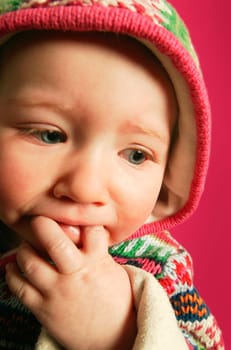 A baby with fingers in mouth