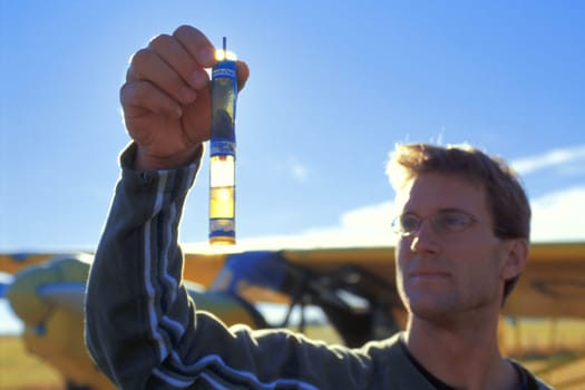 Pilot checking fluid levels
