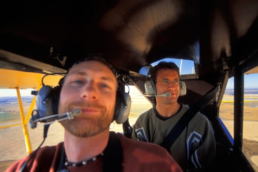 Two men flying in an airplane