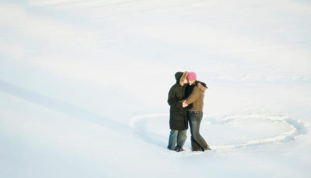 Couple kiss while standing in a heart