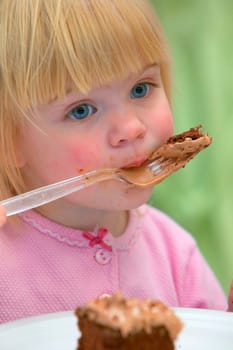 Little girl eating Birthday cake