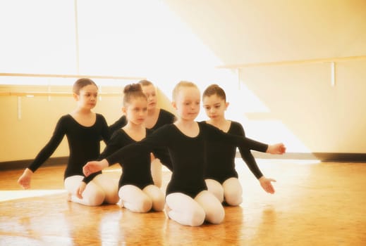 Young girls practice dance routine