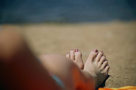 A woman's feet on a beach