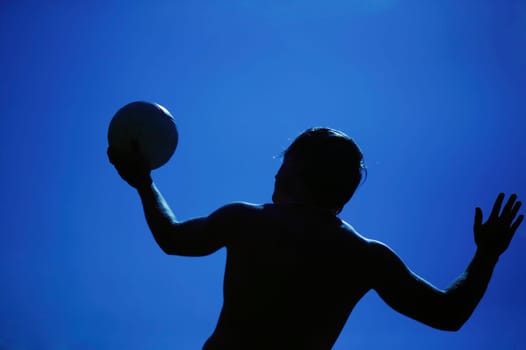 A man serving a volleyball