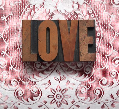 love in old wood type on lace