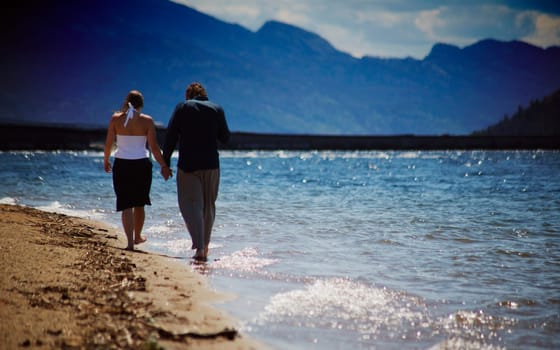 Couple walks on the beach