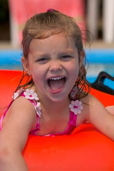 Portrait of little girl playing in Swimming Pool