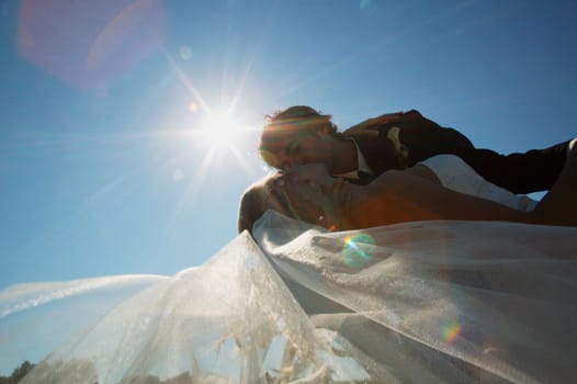 A bride and groom kiss