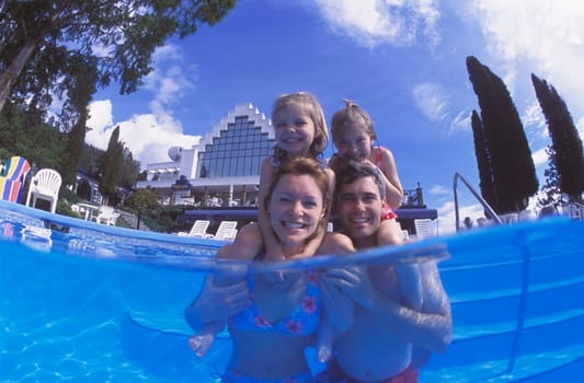 Happy family time in swimming pool