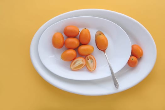 kumquats on white dishes