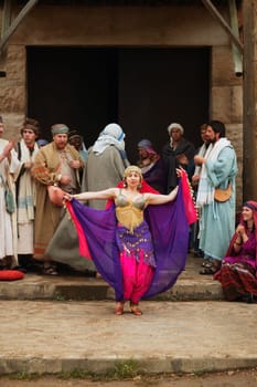 A woman dances in front of men