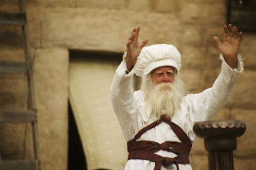 Priest with arms outstretched