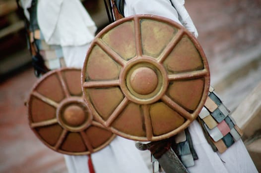 Men hold shields