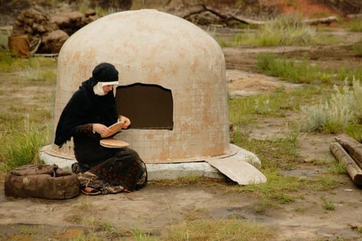 Woman wearing black bakes bread