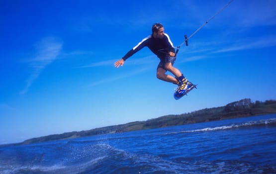 Man wakeboarding on coal Lake Alberta Canada