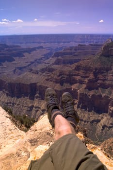 Man sitting on edge of canyon