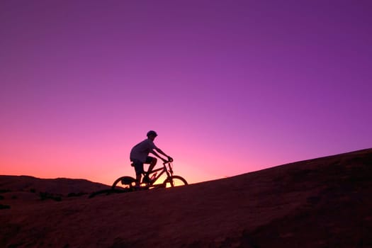 Person on bike at sunset