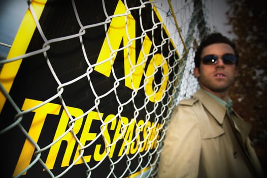 A man beside a no trespassing sign
