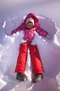 Girl making a snow angel