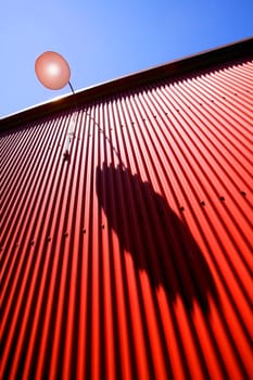 Side view of red metal wall