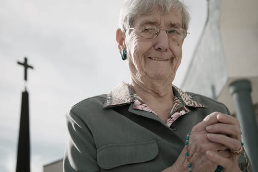 Woman holding rosary beads