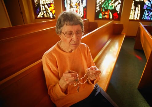 Woman holding rosary beads