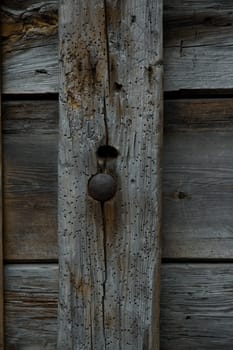 old weathered wooden beam with nail