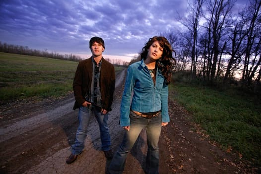 Young trendy man and woman outside