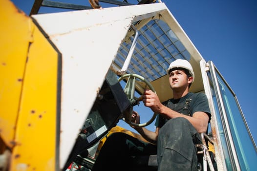 Construction worker using equipment
