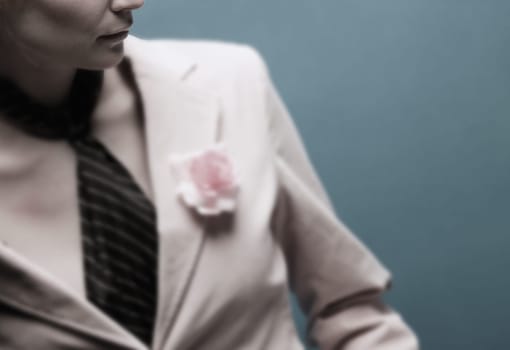 Woman wearing a suit with a pink flower