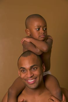 Upset son on father's shoulders
