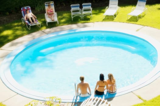 Teens sitting at a pool