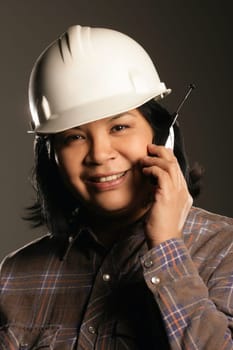 Female site worker on cell phone