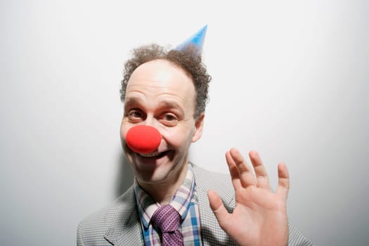 Man wearing a clown's nose and hat