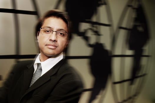 Businessman standing in front of world map