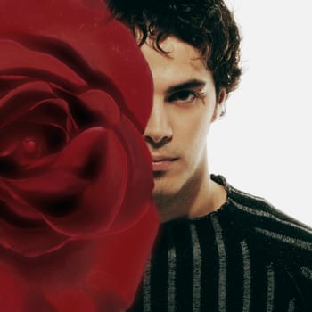 Male model hidden by red rose