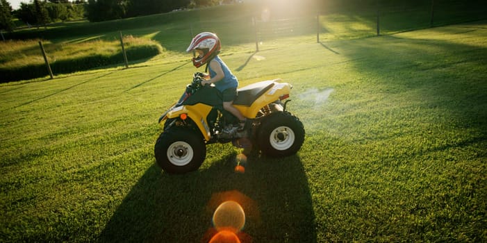 Child riding mini quad bike