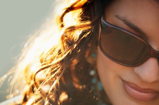 Attractive woman wearing designer sunglasses