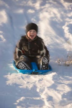 Boy tobogganing