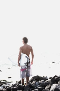 Surfer looking out to sea